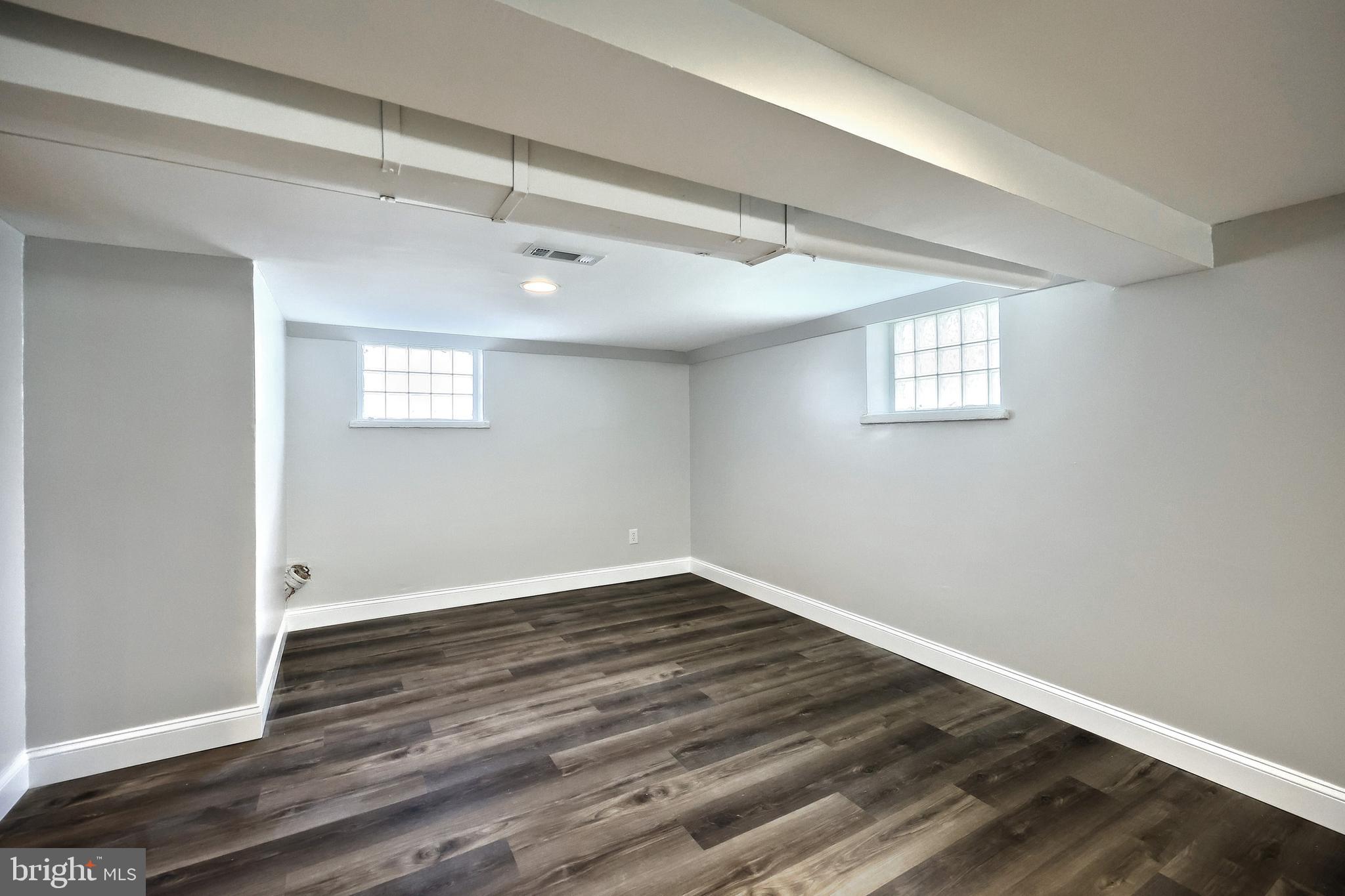 6414 Liberty Road Baltimore, MD 21207 - Photo 38 of 54 a view of an empty room with wooden floor and a window