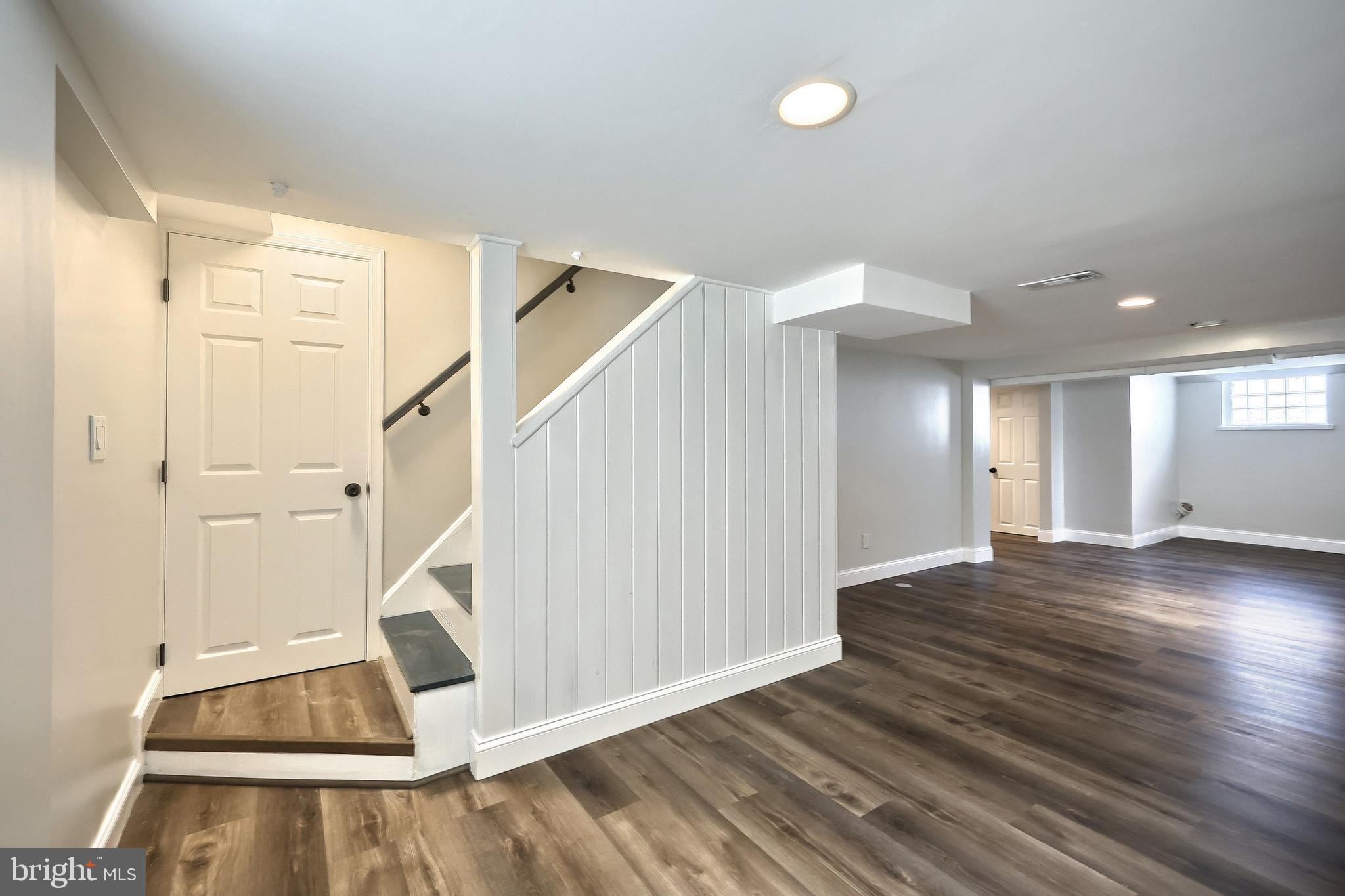 6414 Liberty Road Baltimore, MD 21207 - Photo 39 of 54 a view of a livingroom with wooden floor and white walls
