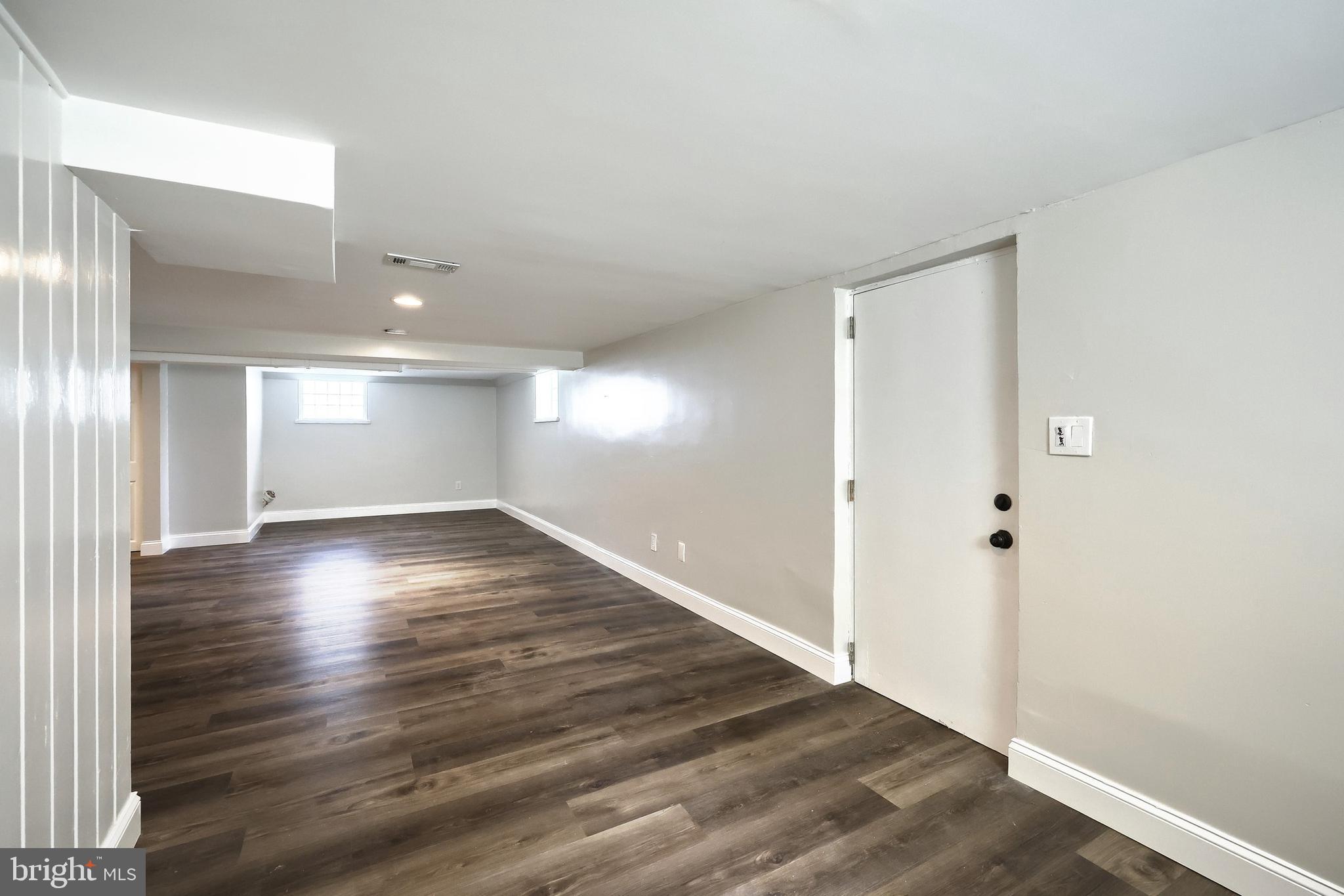 6414 Liberty Road Baltimore, MD 21207 - Photo 40 of 54 a view of wooden floor and windows in an empty room