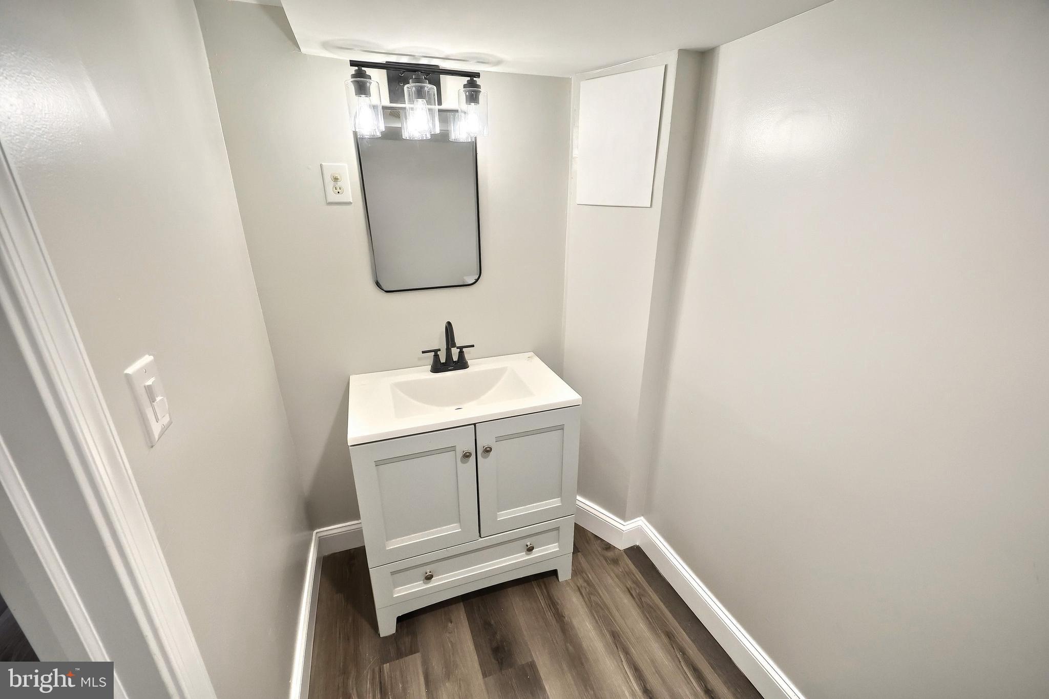 6414 Liberty Road Baltimore, MD 21207 - Photo 43 of 54 a bathroom with a sink a mirror and vanity