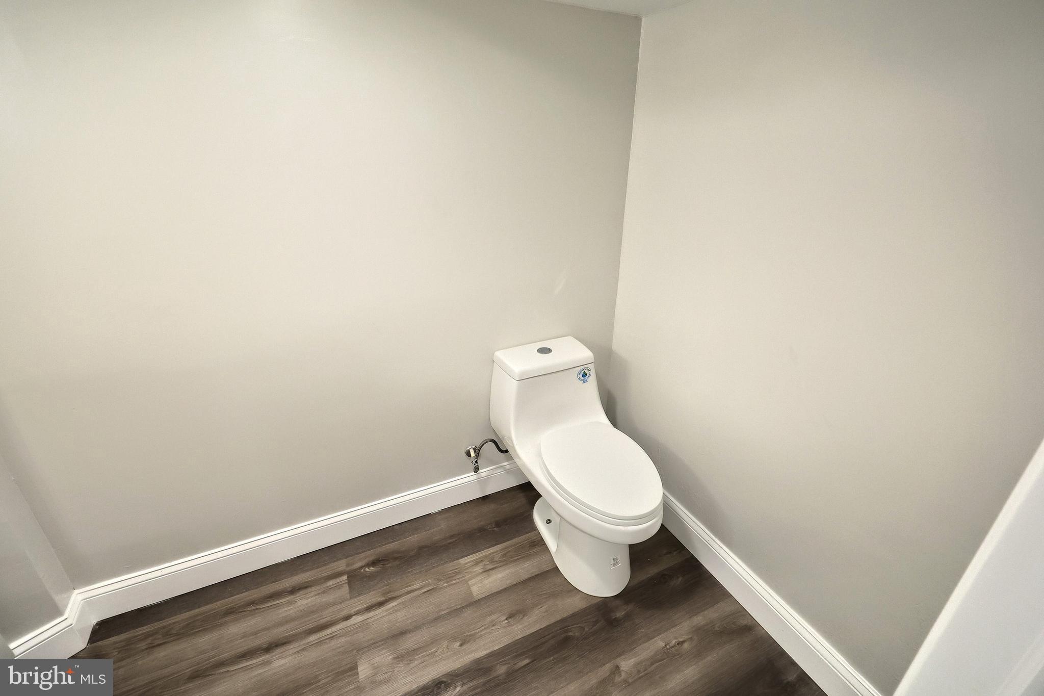 6414 Liberty Road Baltimore, MD 21207 - Photo 44 of 54 a white toilet sitting next to a white wall