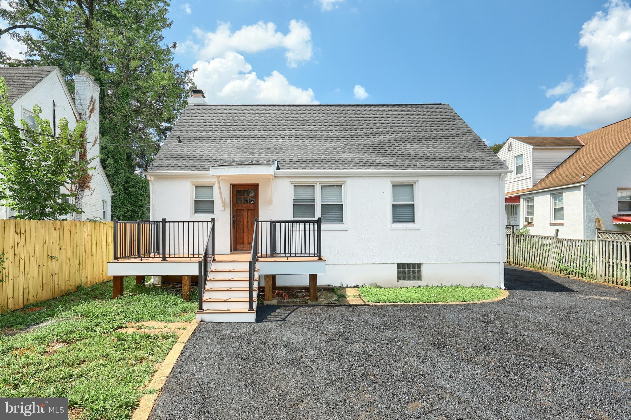 6414 Liberty Road Baltimore, MD 21207 - Photo 8 of 54 a front view of a house with a yard and garage