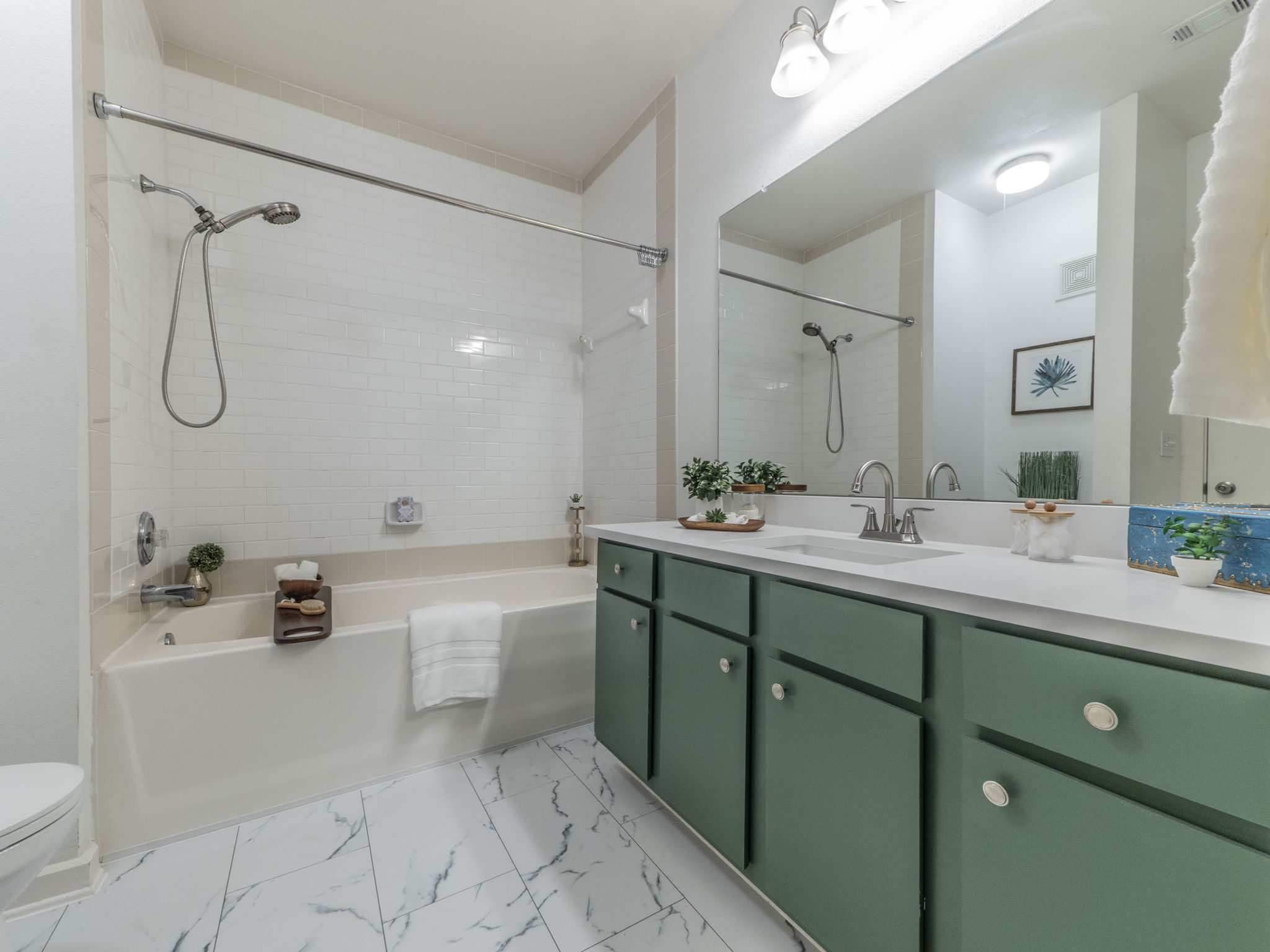 1201 Grove Boulevard, Unit 702 Austin, TX 78741 - Photo 11 of 19 a bathroom with a granite countertop sink a toilet and a bathtub