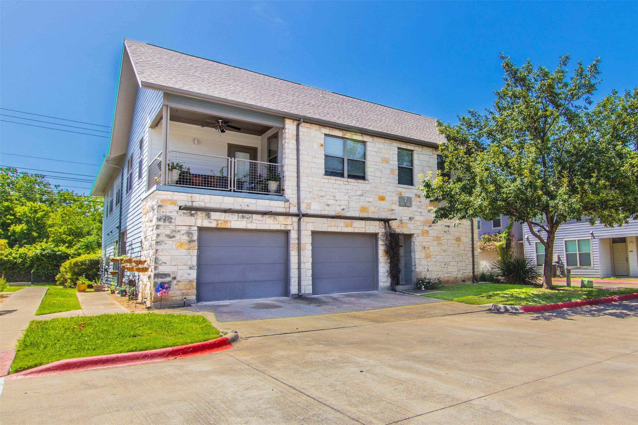 1201 Grove Boulevard, Unit 702 Austin, TX 78741 - Photo 17 of 19 a front view of a house with a yard and garage