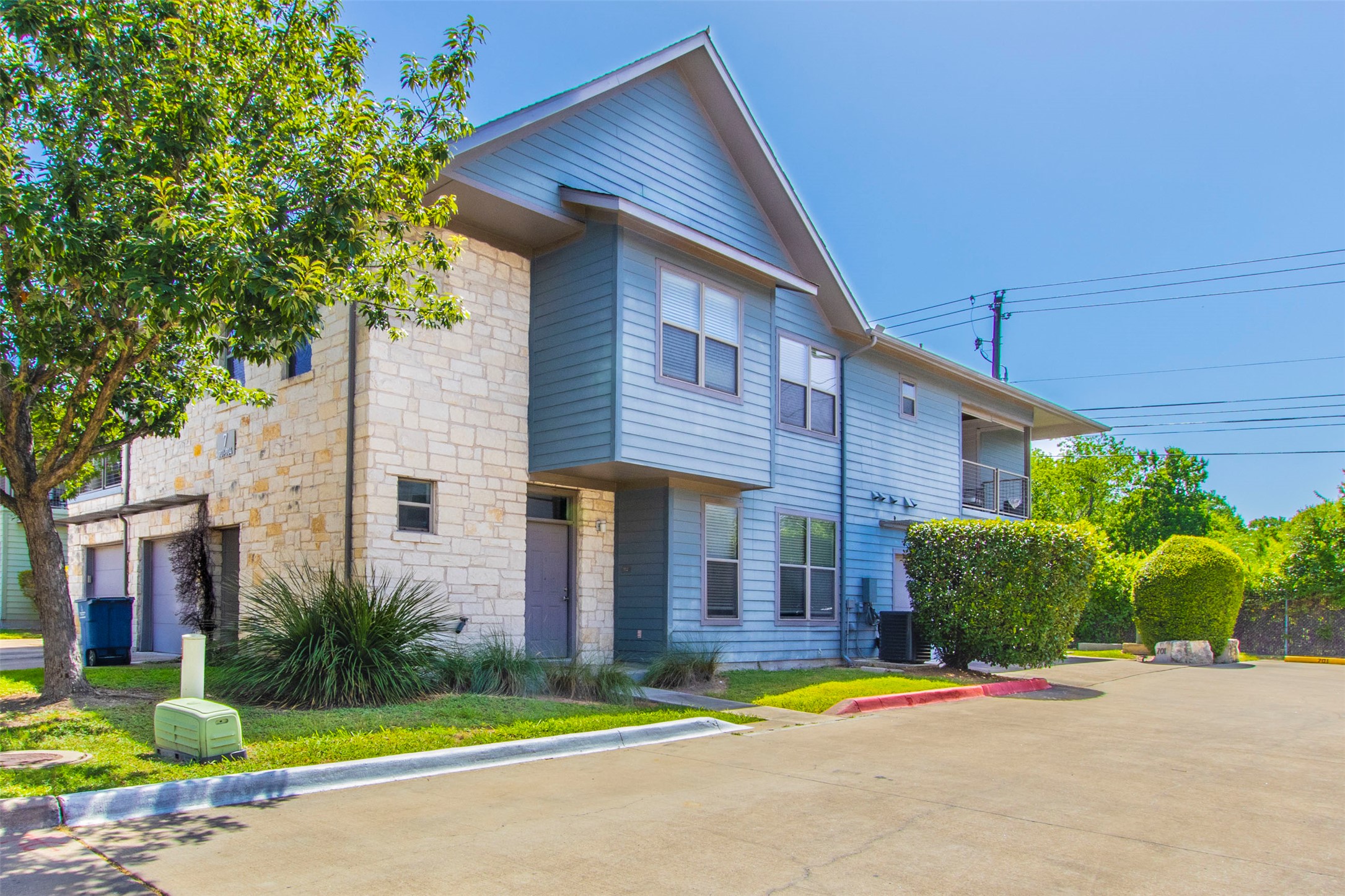 1201 Grove Boulevard, Unit 702 Austin, TX 78741 - Photo 2 of 19 a backyard of a house with plants and large trees