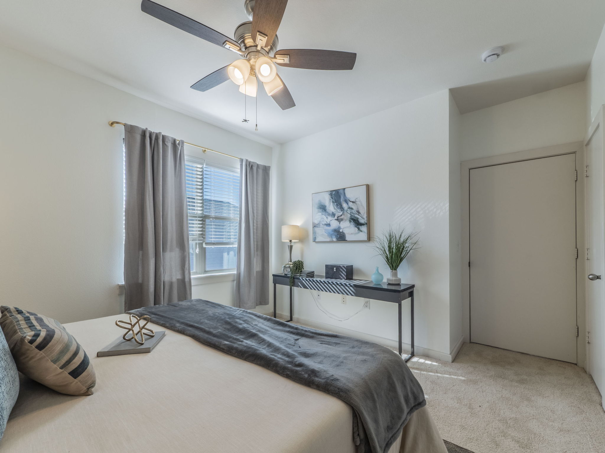 1201 Grove Boulevard, Unit 702 Austin, TX 78741 - Photo 10 of 19 a bedroom with a bed and a chandelier