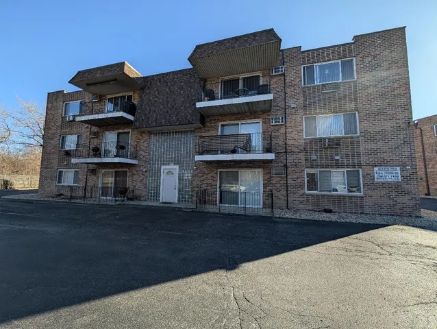 a front view of a residential apartment building with a yard