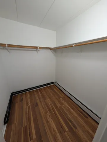 a view of a room with wooden floor and small stairs