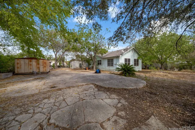 a front view of house with a yard and trees
