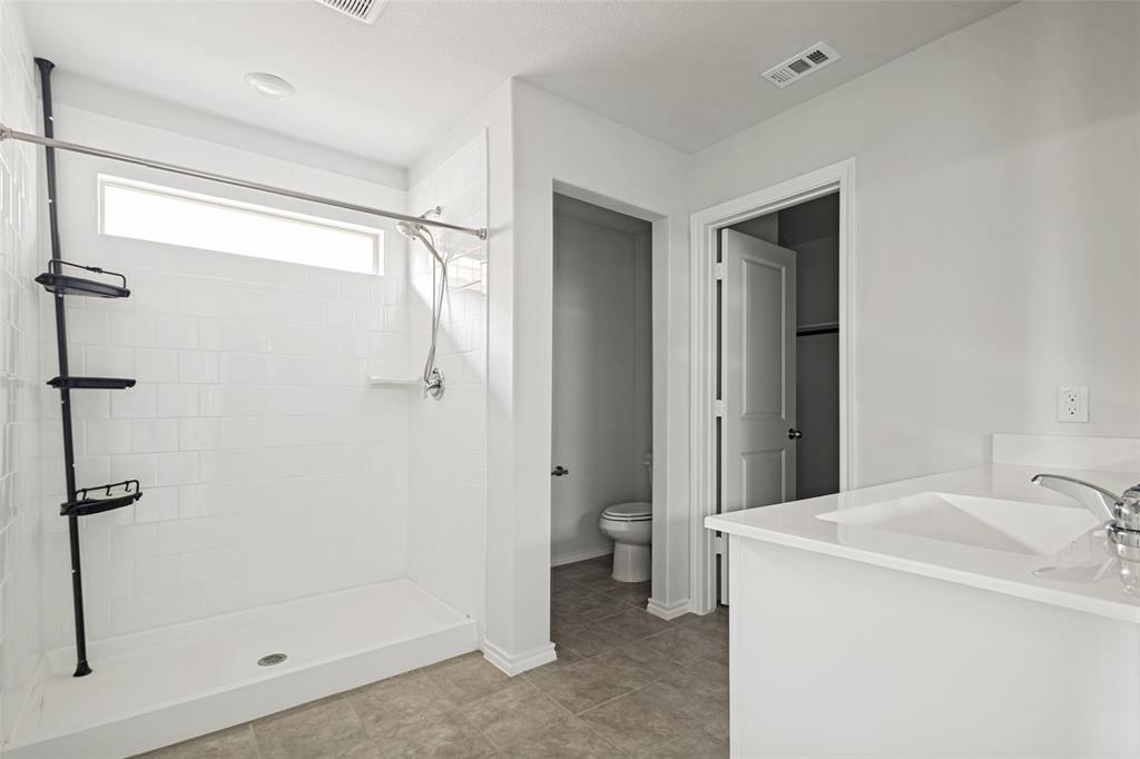 621 Spaulding Street Justin, TX 76247 - Photo 19 of 22 a bathroom with a shower and a sink