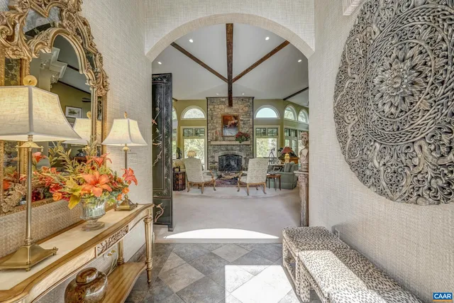 a living room with furniture fireplace and a large window