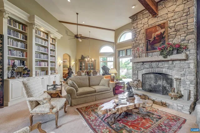a dining room with furniture a chandelier and wooden floor