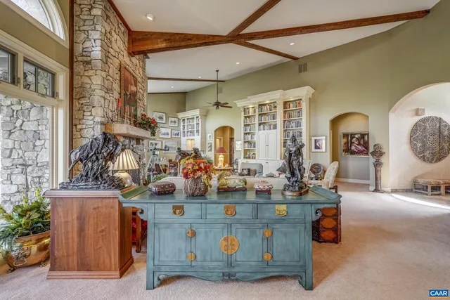 a dining room with furniture a rug and a large window