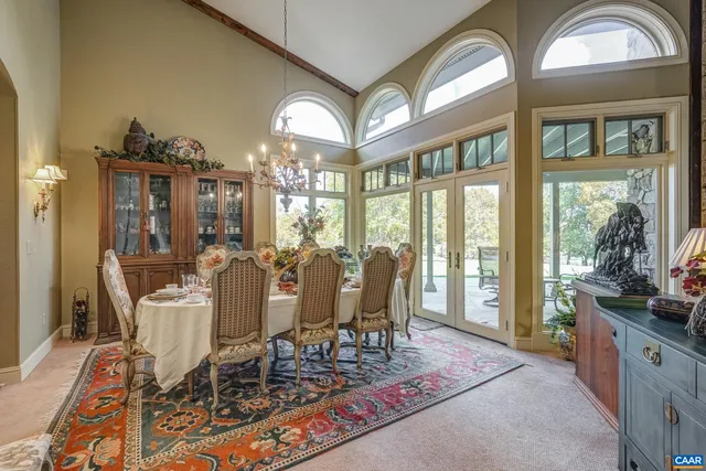 a living room with furniture a ceiling fan and a large window