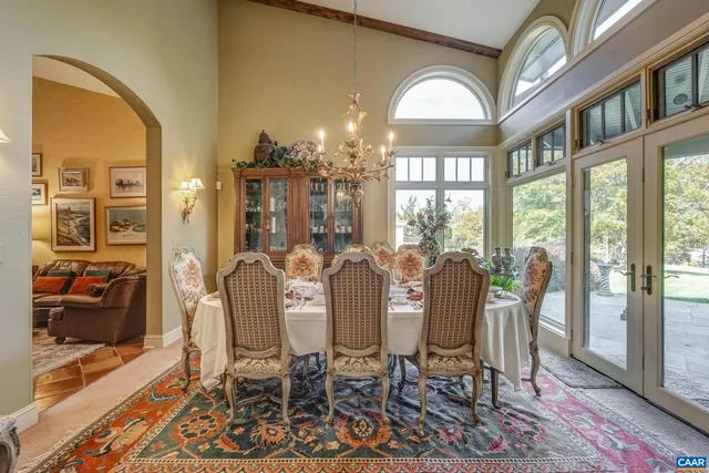 a bathroom with a granite countertop sink a large mirror and a bathtub