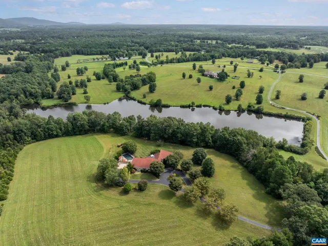 an aerial view of a houses with a yard
