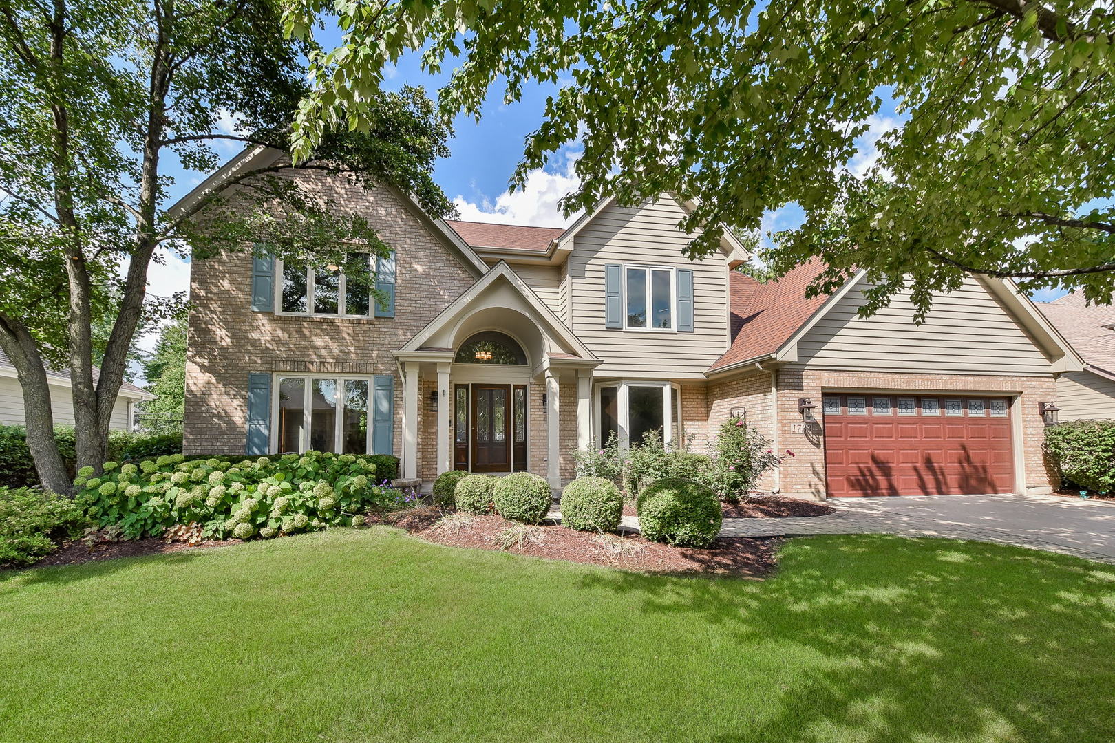 1733 Greene Ridge Drive Naperville, IL 60565 - Photo 1 of 1 a front view of a house with a garden and plants