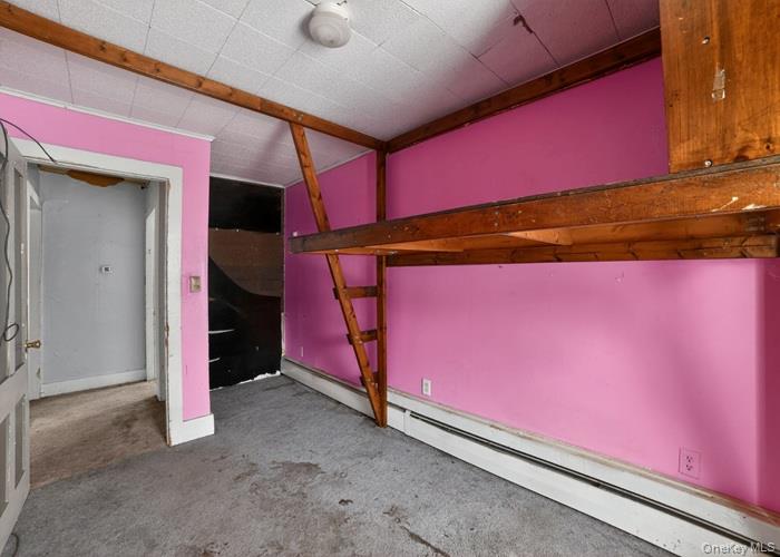 62 George Street Owego, NY 13827 - Photo 12 of 21 Unfurnished bedroom featuring a baseboard heating unit and carpet floors