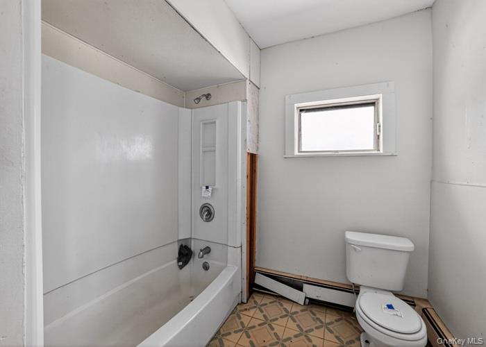 62 George Street Owego, NY 13827 - Photo 20 of 21 Full bath featuring a baseboard radiator, bathtub / shower combination, and light flooring