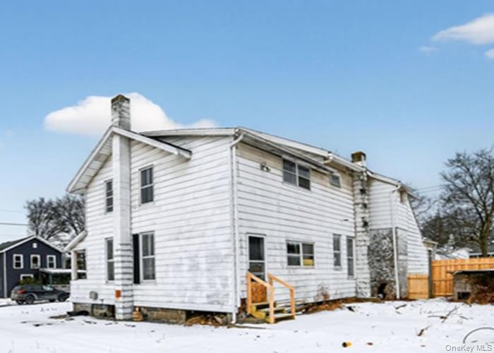 62 George Street Owego, NY 13827 - Photo 4 of 21 Snow covered back of property featuring a chimney