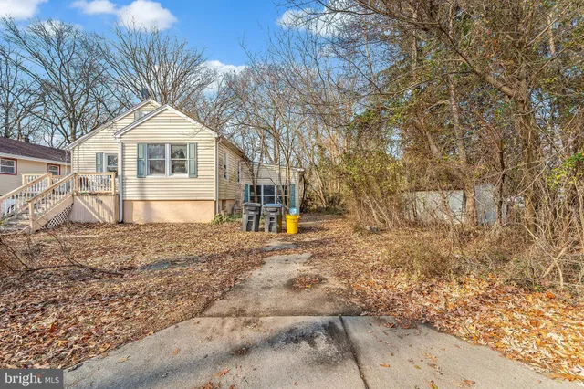 a view of a white house with a yard