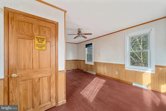 an entryway with wooden floor and cabinet
