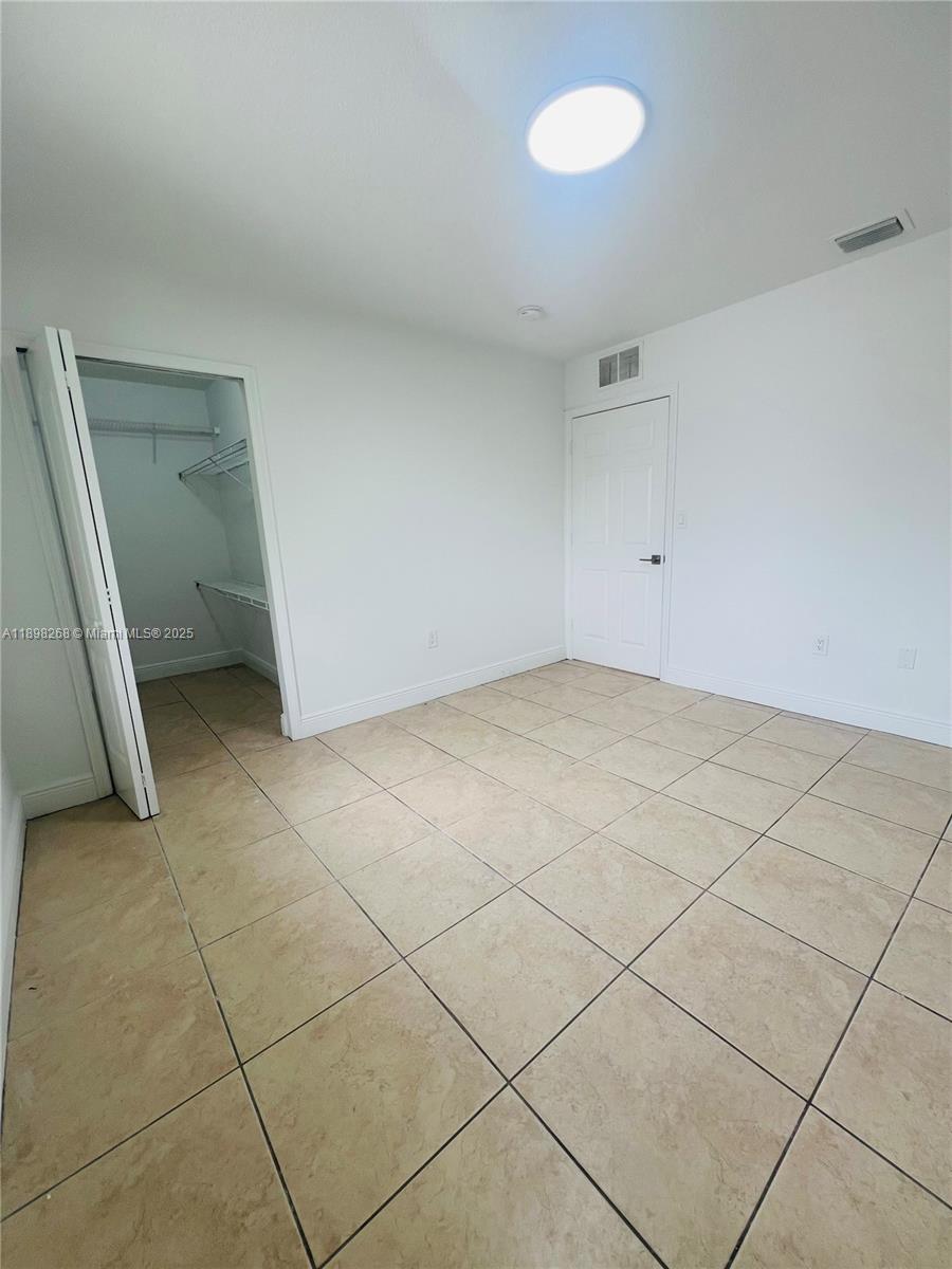 2185 Northwest 16th Terrace, Unit 16 Miami, FL 33125 - Photo 11 of 14 a view of an empty room and window