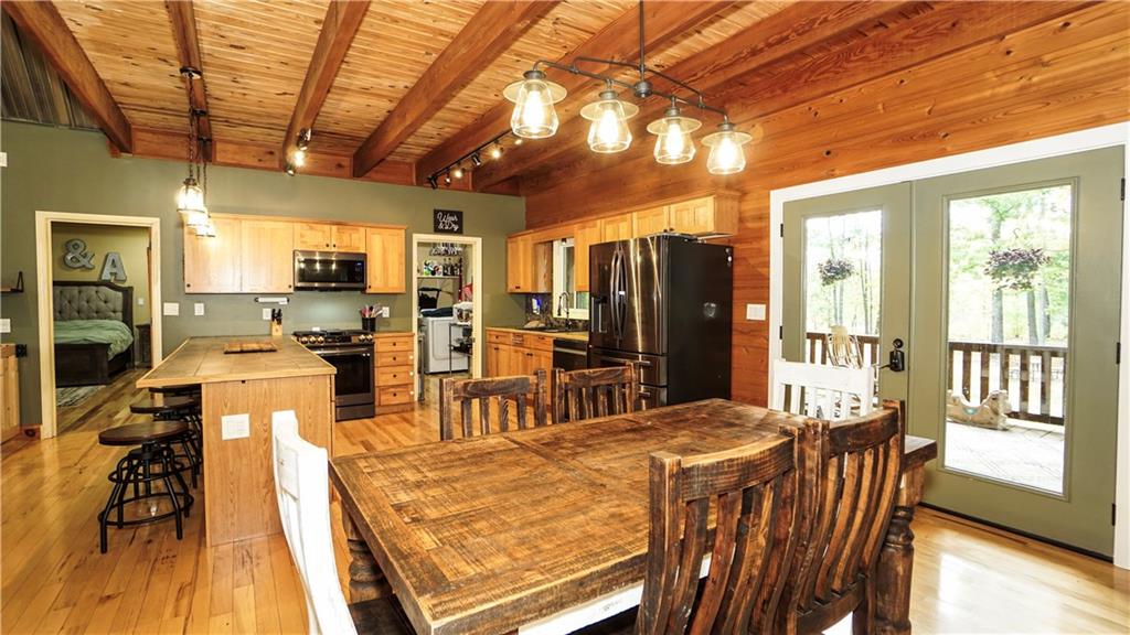 169 Williams Road Taylorsville, GA 30178 - Photo 13 of 84 a view of a dining room with furniture a chandelier and wooden floor