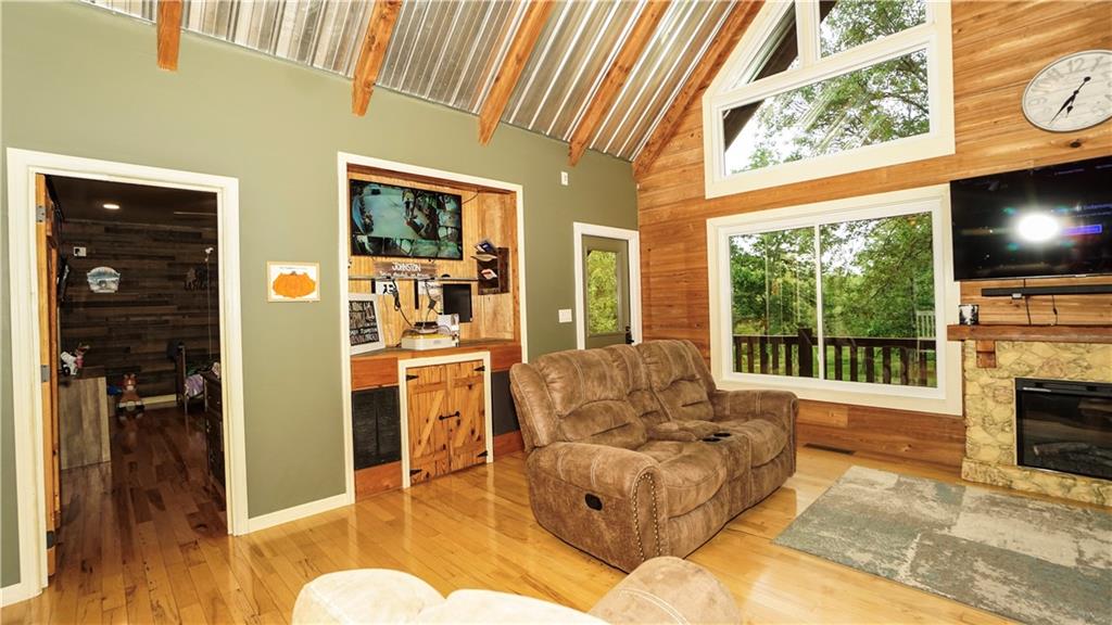 169 Williams Road Taylorsville, GA 30178 - Photo 23 of 84 a living room with furniture a flat screen tv and a floor to ceiling window