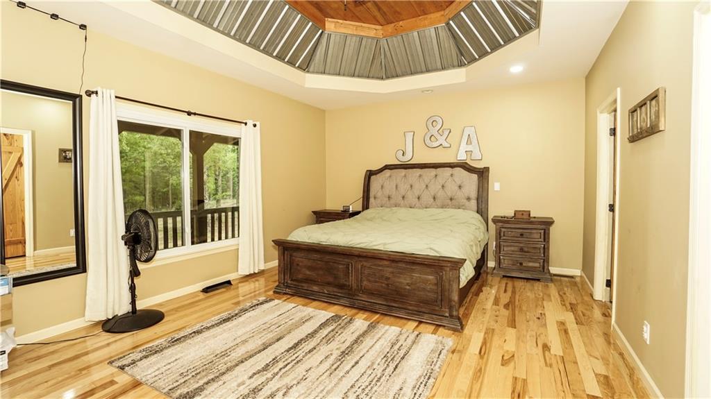 169 Williams Road Taylorsville, GA 30178 - Photo 28 of 84 a spacious bedroom with a bed and wooden floor