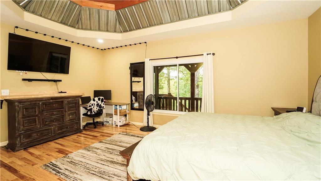 169 Williams Road Taylorsville, GA 30178 - Photo 29 of 84 a bedroom with a bed and a flat tv screen on dresser