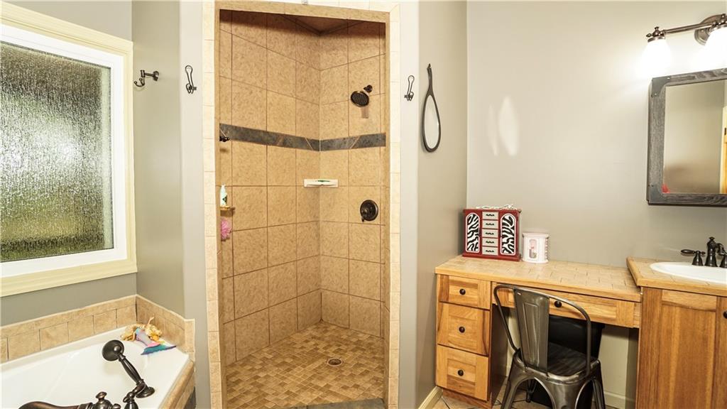 169 Williams Road Taylorsville, GA 30178 - Photo 32 of 84 a bathroom with a shower a sink and a mirror