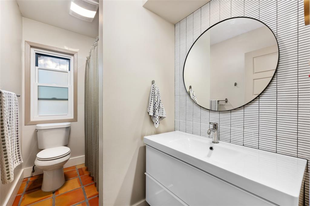 2210 Red Fox Road Austin, TX 78734 - Photo 32 of 40 Modern bath boasts unique tile flooring and a clean, minimalist vanity with a sleek round mirror.