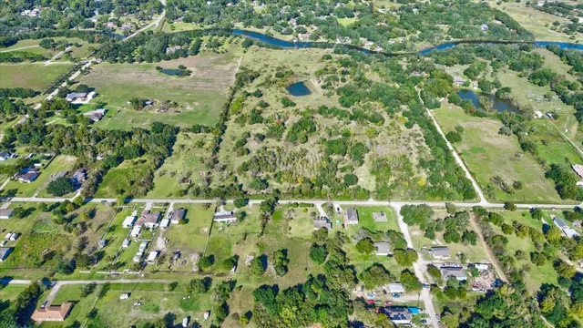 a backyard of a house with lots of green space and trees all around