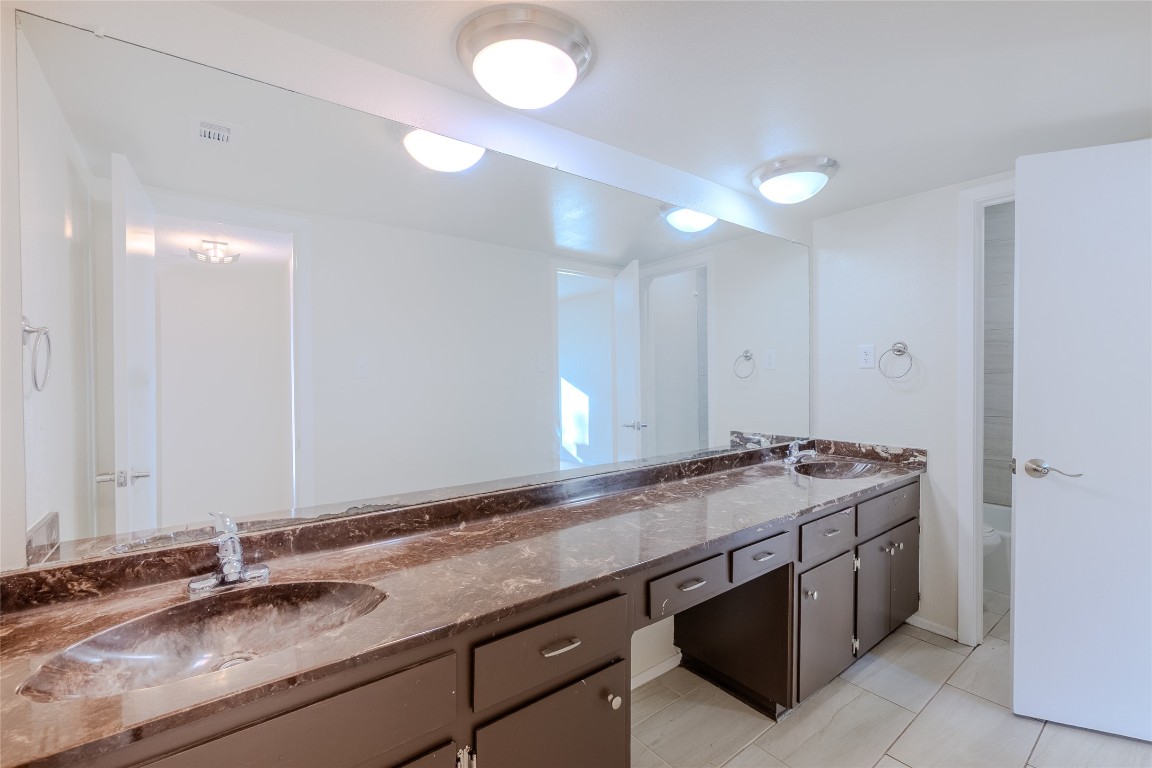 8203 Beaver Brook Lane Austin, TX 78748 - Photo 15 of 34 a bathroom with a sink double vanity and a mirror