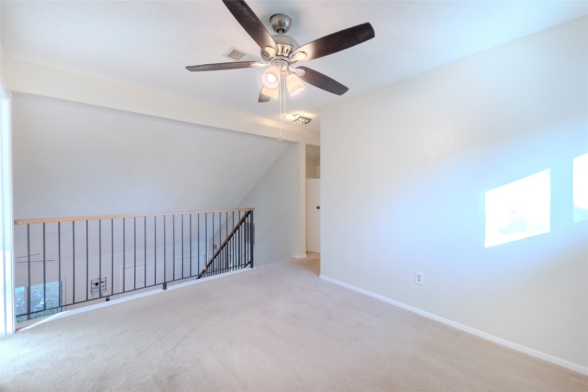 8203 Beaver Brook Lane Austin, TX 78748 - Photo 19 of 34 an empty room with fan and windows
