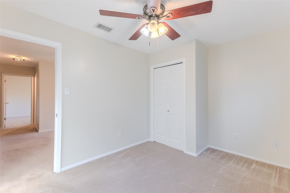 8203 Beaver Brook Lane Austin, TX 78748 - Photo 29 of 34 an empty room with a fan and a fan