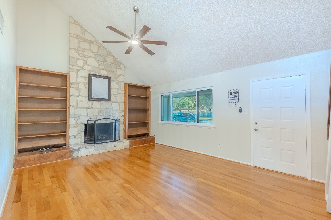 8203 Beaver Brook Lane Austin, TX 78748 - Photo 3 of 34 a view of a livingroom with a fireplace a ceiling fan and wooden floor