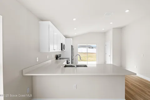a kitchen with stainless steel appliances granite countertop a stove a refrigerator and a microwave