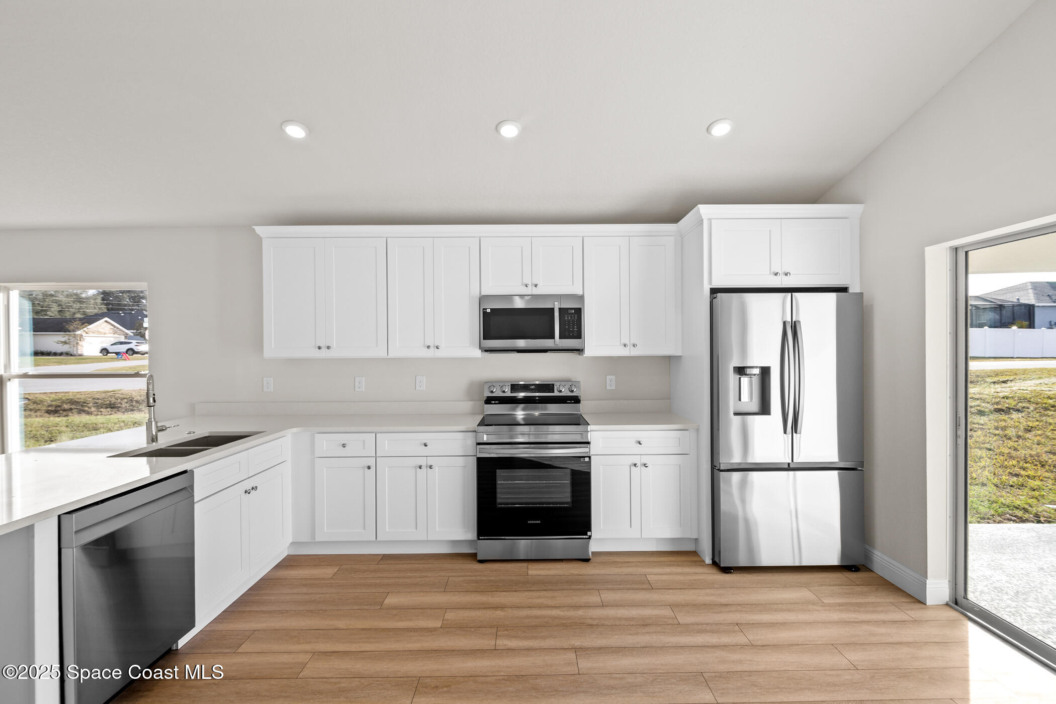 5346 Southeast 91st Street Ocala, FL 34480 - Photo 12 of 38 a kitchen with stainless steel appliances granite countertop a stove a refrigerator and a microwave