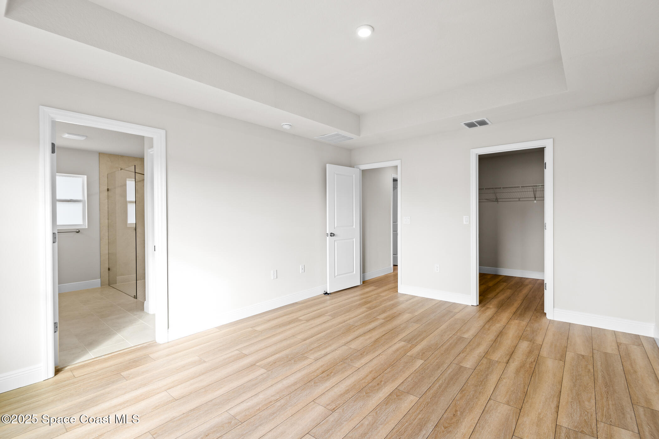 5346 Southeast 91st Street Ocala, FL 34480 - Photo 18 of 38 a view of an empty room with wooden floor