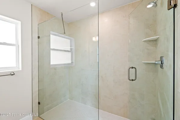 a bathroom with a glass shower door and a bathtub