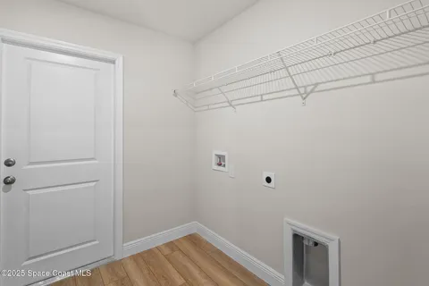 a view of a room with wooden floor