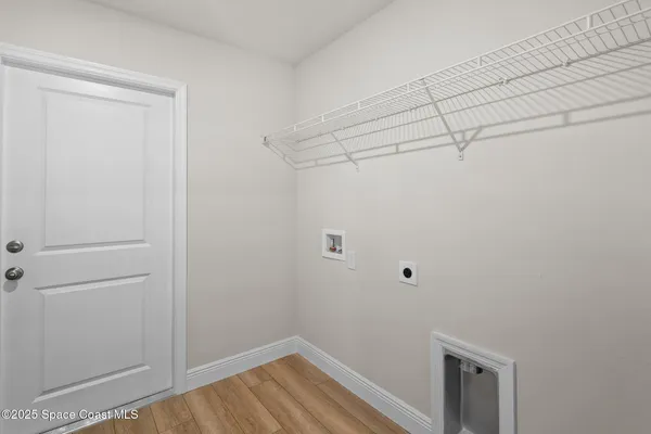 a view of a room with wooden floor