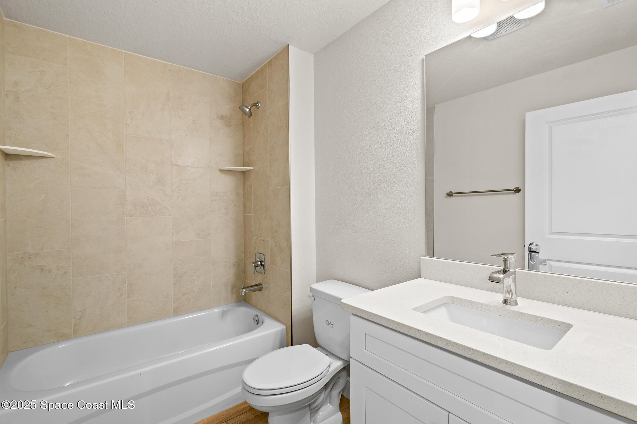 5346 Southeast 91st Street Ocala, FL 34480 - Photo 30 of 38 a bathroom with a granite countertop bathtub shower sink vanity mirror and toilet