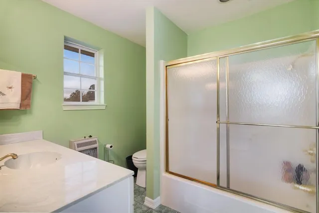 a large white kitchen with a sink and cabinets