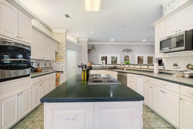 a spacious bathroom with a sink a large mirror and a shower