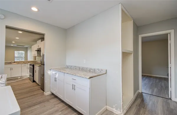 a view of a kitchen cabinets and wooden floor