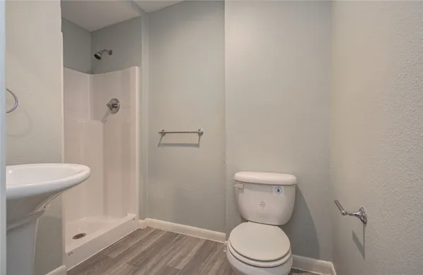a white toilet sitting next to a bathroom sink