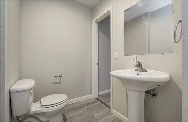 a bathroom with a sink toilet and a mirror